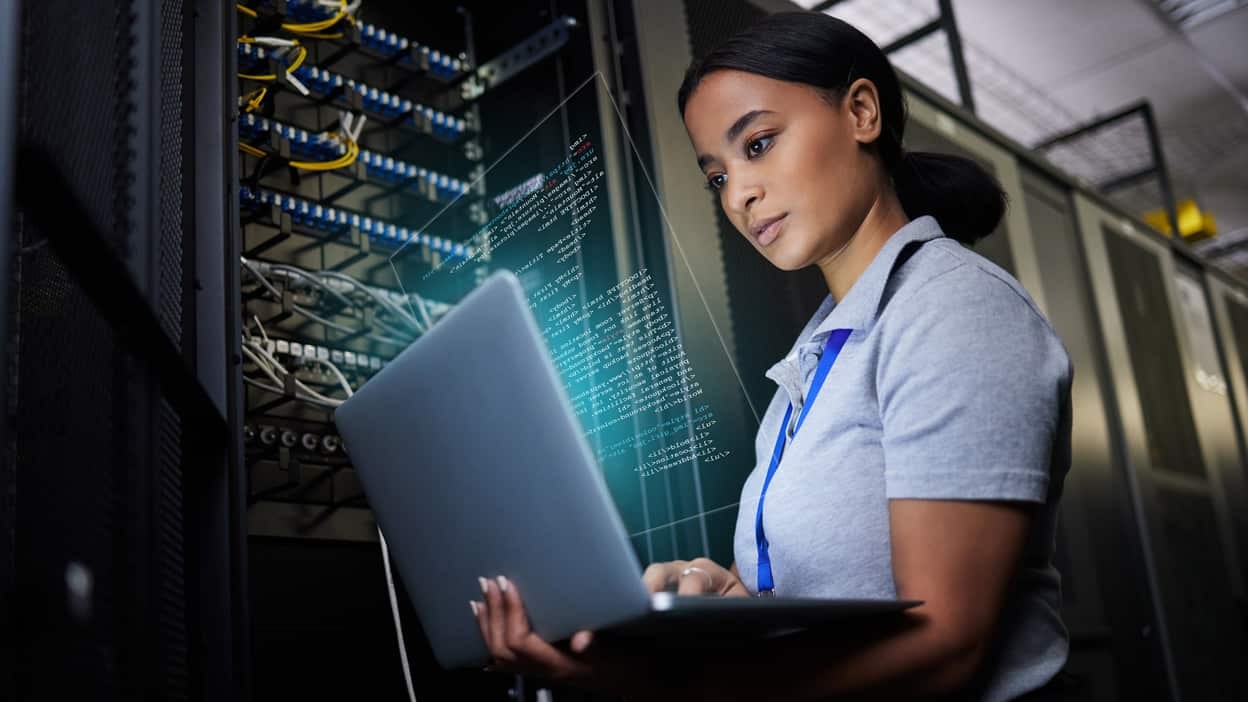 woman-working-on-a-laptop-by-mainframe