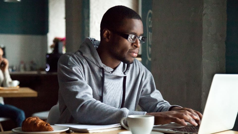 man on a laptop sitting at a desk