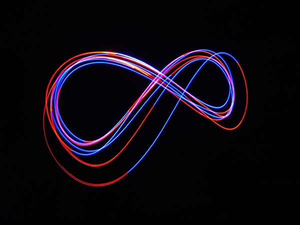neon infinity sign on a black background