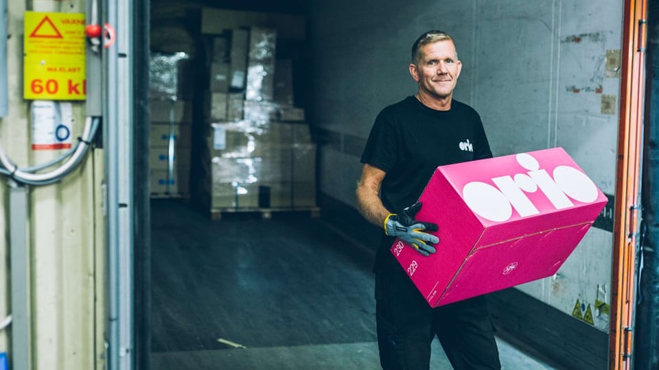 orio employee holding a branded box in their warehouse