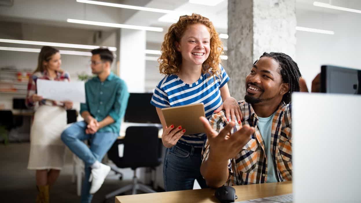 Business people having fun and chatting at workplace office