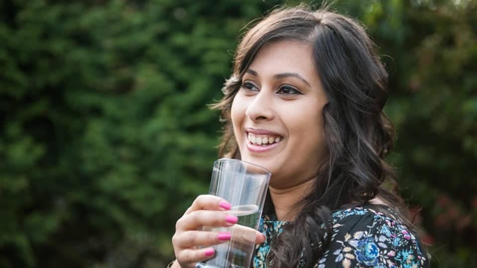 woman drinking a glass of water