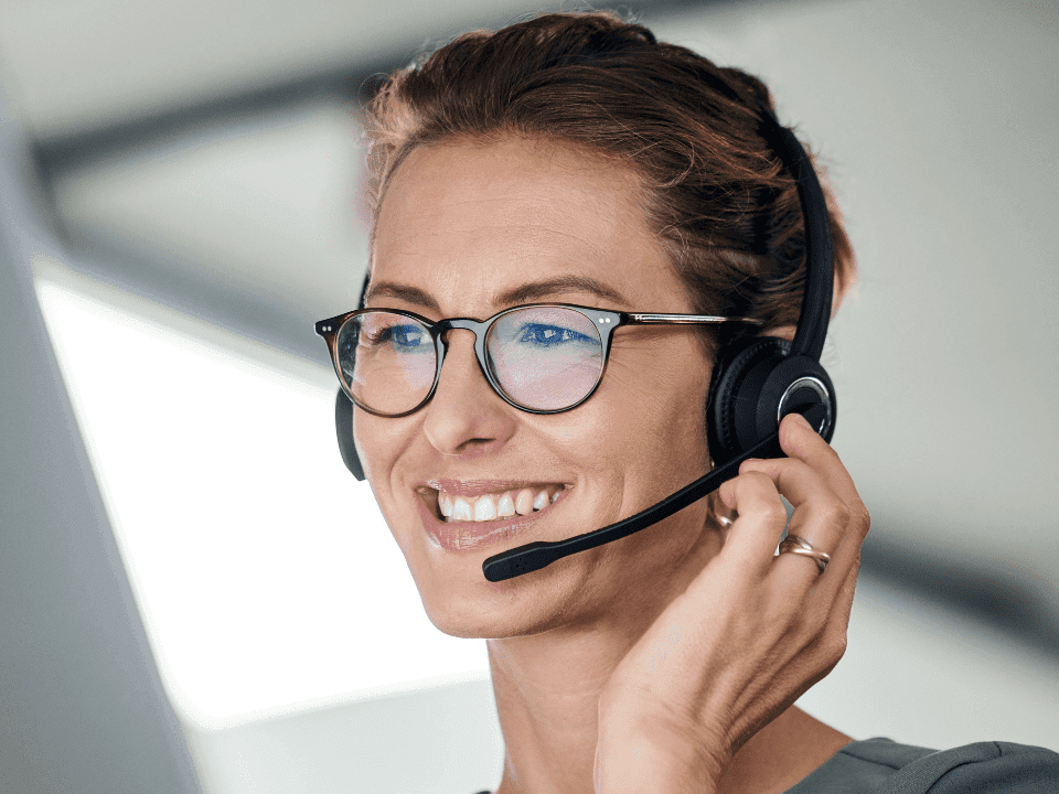smiling call centre worker with headset on