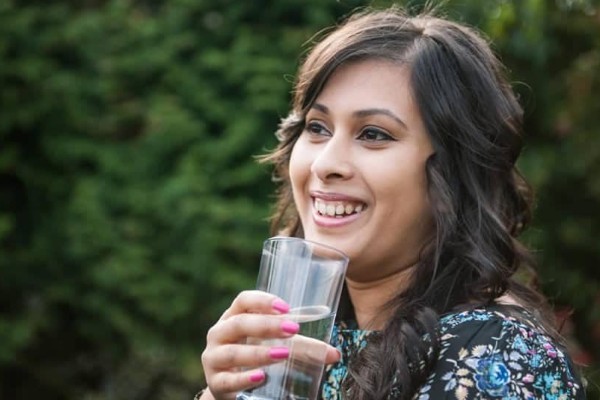 woman drinking a glass of water