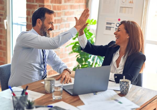 Man and woman high-fiving 