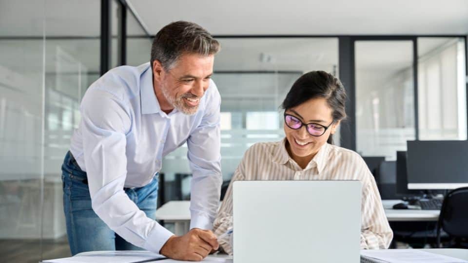 Man and woman working together on a laptop