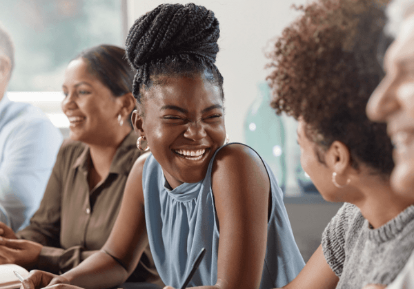 three women sitting together and smiling