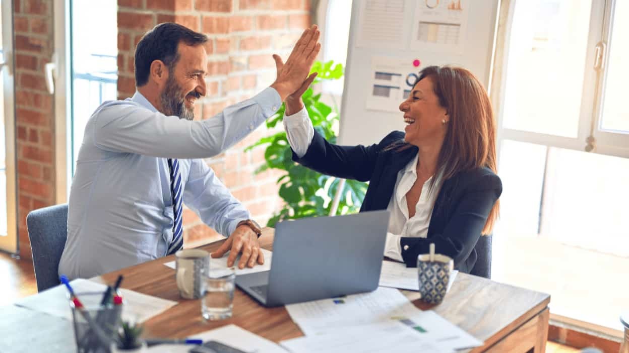 man and woman high fiving