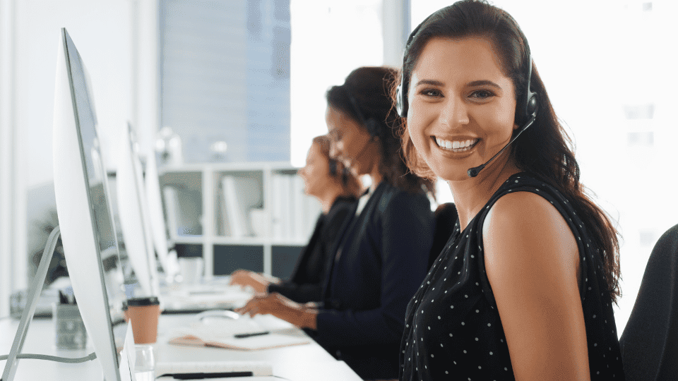 Woman wearing a headset at a PC