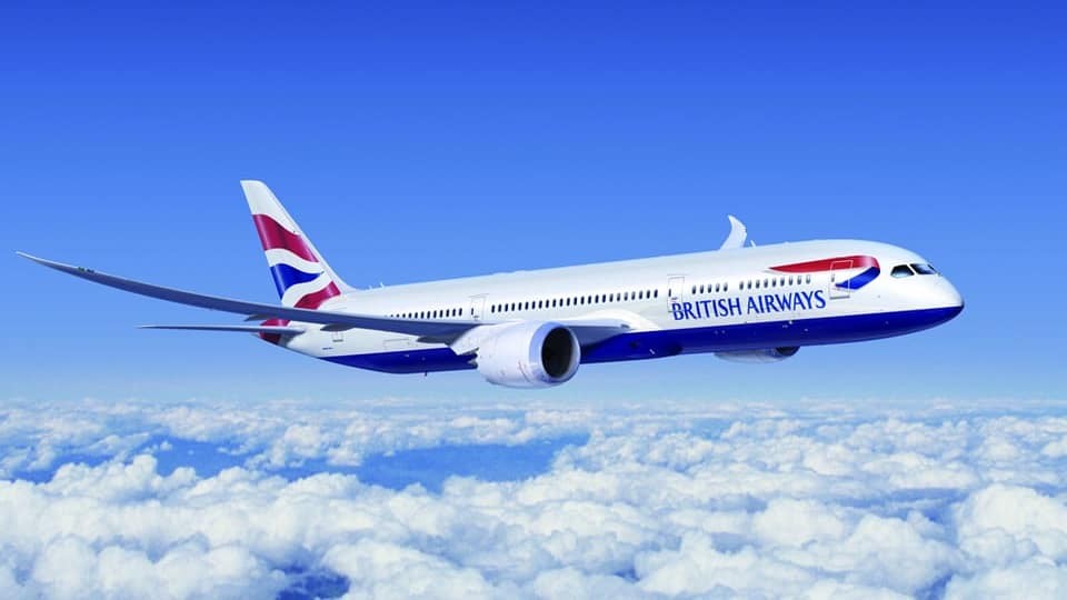 BA plane in the blue sky against clouds