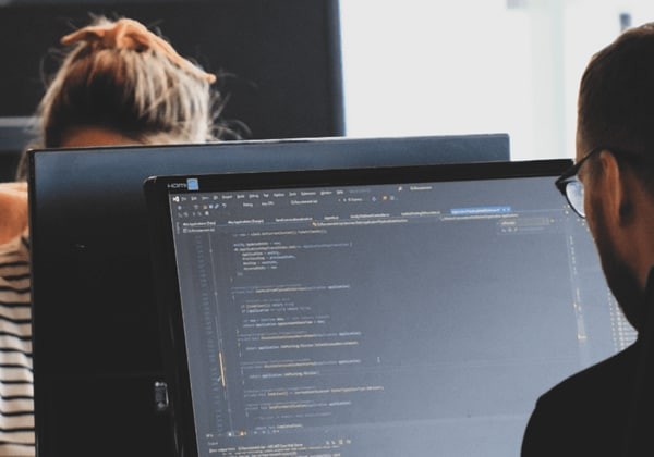 a man and woman working on computers