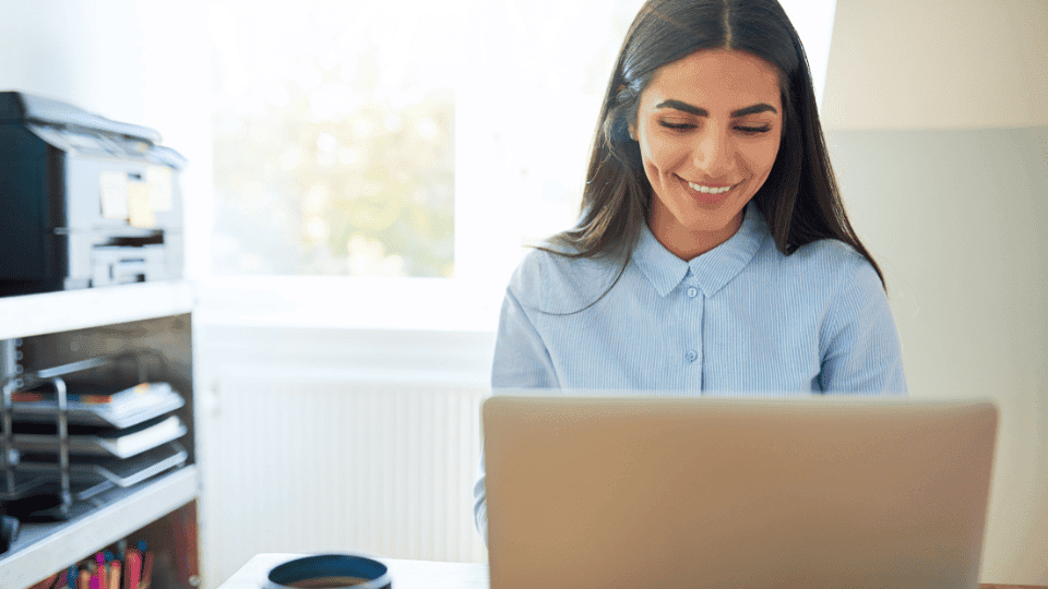 Smiling woman working on a laptop
