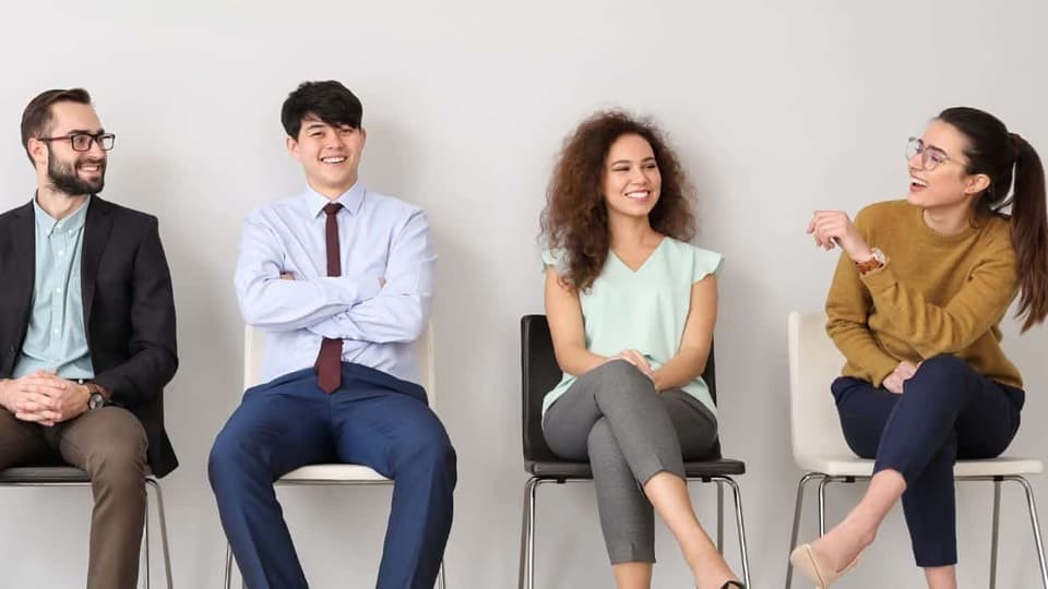 employees sitting on chairs talking